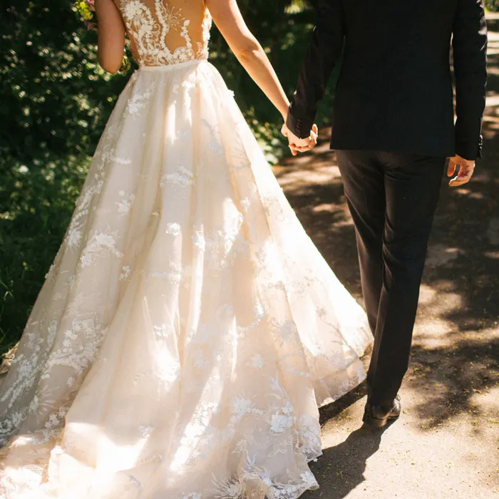 A bride and groom walking in the Kent countryside