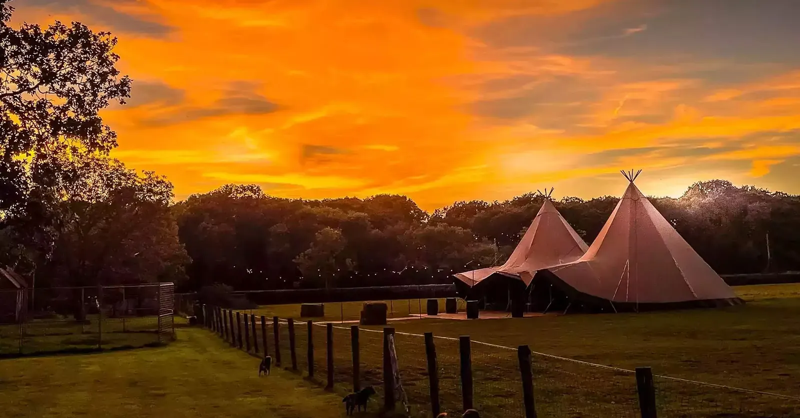 A Holmsted Events wedding tipi at sunset